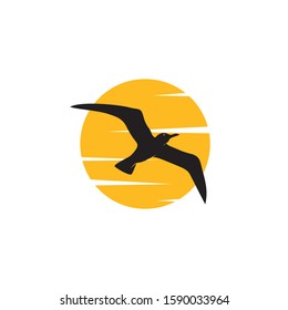 A simple logo of a seagull flying past a cloudy sun.