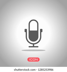 Simple microphone icon. Icon under spotlight. Gray background