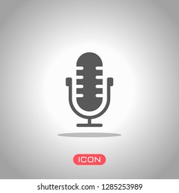 Simple microphone icon. Icon under spotlight. Gray background
