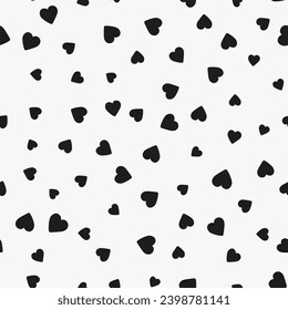 Simple minimalistic seamless pattern, black hand-drawn hearts of different sizes on a white background. Sugar sprinkles, confetti.