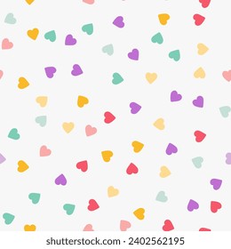 Simple minimalistic seamless pattern, playful hand-drawn cute hearts of different colors on a white background. Sugar sprinkles on a donut, romantic background, Valentine's Day.