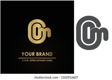 Simple, modern, and the luxury letter "COM" vector logo key shape in gold color