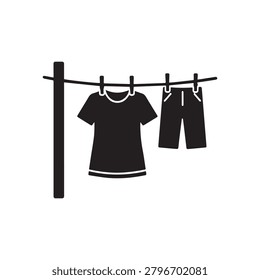 A simple, monochromatic illustration shows a clothesline with a black T-shirt and black shorts hanging to dry, attached by clothespins to a horizontal line supported by a vertical pole. The design is .