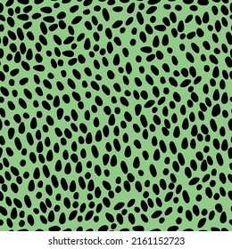 A simple pattern is abstract. Black spots on a bright green background. Fashionable print for textiles, wallpaper and packaging.