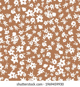 Simple pattern in ditsy flower. Burnt orange background. Small off white flowers. Vector texture. Fashionable print for textiles and wallpaper.