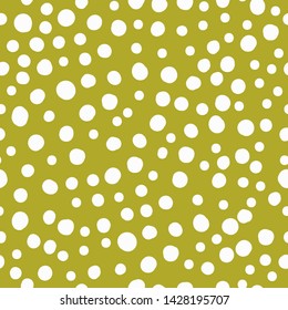 A simple pattern of dots. Mustard background, white dots,spots. The print is well suited for textiles,banners, packaging and Wallpaper.