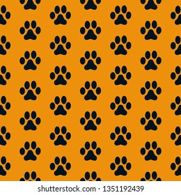 A simple pattern of footprints. Orange background, cute black animal tracks. Print is well suited for textiles, banners, postcards, packaging.