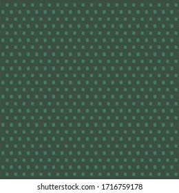 Simple pattern with small spots, in shades of green. Textile material.