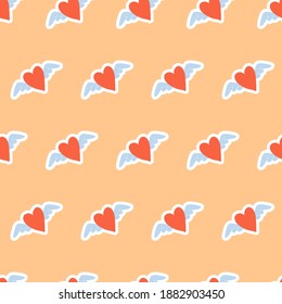 Simple pattern for wrapping paper or textile with red heart and wings on yellow background