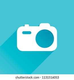 Simple photo camera. Technology icon. Gray icon with long shadow in bottom left corner on blue background