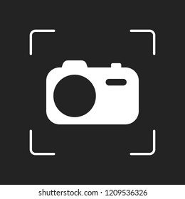 Simple photo camera. Technology icon. White object in camera autofocus on dark background
