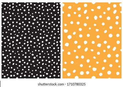 Simple Rough Dotted Seamless Vector Patterns. White Hand Drawn Brush Dots Isolated on a Black and Warm Yellow Background. Infantile Style Geometric Repeatable Print. Irregular Polka Dots Backdrop.