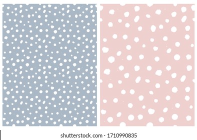 Simple Rough Dotted Seamless Vector Patterns. White Hand Drawn Brush Dots Isolated on a Pale Blue and Pastel Pink Background. Infantile Style Geometric Repeatable Print. Irregular Polka Dots Backdrop.