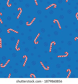 Simple seamless Christmas pattern. Caramel cane and snowflakes. Dark blue background. Fashionable print for postcards, Christmas packaging and Wallpaper.