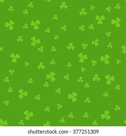 Simple seamless green St. Patrick's day background with clover leaves.