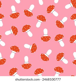 Simple seamless pattern with cute fly agarics. Vector graphics.