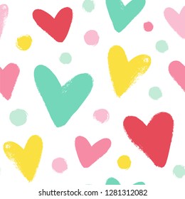 Simple seamless pattern with hearts and dots in cute colors.