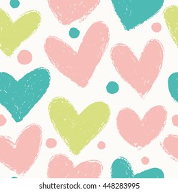 Simple seamless pattern with hearts and polka dots in pastel colors.