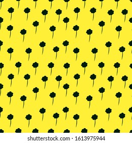 A simple seamless summer pattern with green flowers on a yellow background. 