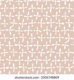 A simple seamless vector pattern on a pinkish-beige background made from hand-drawn brush strokes and circles. White crosses in a mosaic pattern.