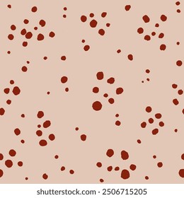 A simple seamless vector pattern with red-brown speckles on a pinkish-beige background.