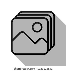 Simple stack of pictures. Black object with long shadow on white background