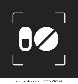 simple symbols of pills or vitamins. White object in camera autofocus on dark background