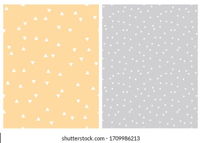 Simple Trangle Vector Patterns. White Triangles on a Pale Yellow and Light Gray Background. Cute Pastel Color Geometric Irregular Backdrop. Abstract Confetti Rain Print. Abstract Minimalist Tile.