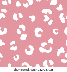 Simple trend pattern. White spots of a leopard. Pink background. Vector texture. Fashionable print for Wallpaper.
