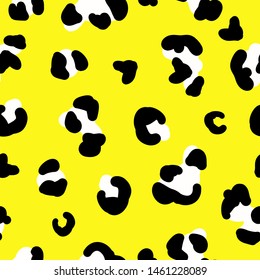 Simple trend pattern. Yellow background, black and white leopard spots ornament. The print is well suited for textiles,Wallpaper,packaging and banners.