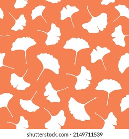 Simple vector pattern with hand drawn leaves of ginkgo biloba on orange background. Vector illustration. Floral seamless pattern. Ginkgo leaves pattern. Seamless pattern with ginkgo leaves.