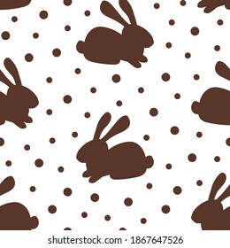 Simple vector seamless polka dot pattern. Chocolate bunny on a white background. For prints of fabrics, textile products, packaging design. Sweets, dessert.