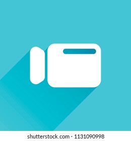 Simple video camera icon. Gray icon with long shadow in bottom left corner on blue background
