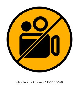 Simple video camera icon. not allowed, black object in warning sign with orange background color