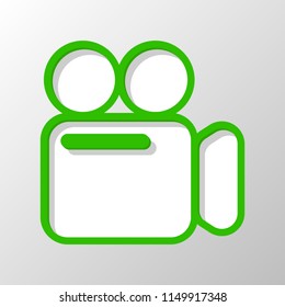 Simple video camera icon. Paper style. Cut symbol with green bold contour on shape and simple shadow