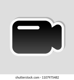 Simple video camera icon. Sticker style with white border and simple shadow on gray background