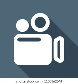 Simple video camera icon. White flat icon with long shadow on background
