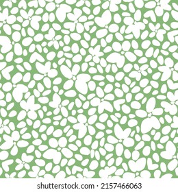 Simple vintage abstract pattern. white flowers, leaves, spots. green background. Fashionable print for textiles, wallpaper and packaging.