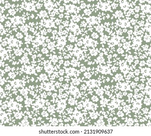 Simple vintage floral pattern. Small white flowers on a green background. Simple cute pattern in small white flowers on gray background. Liberty style. Ditsy print.