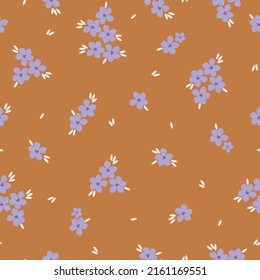 Simple vintage pattern. Lilac flowers, white leaves. Terracotta background. Fashionable print for textiles, wallpaper and packaging.