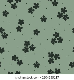 Simple vintage pattern. small dark green flowers and dots. light green background. Fashionable print for textiles and wallpaper.