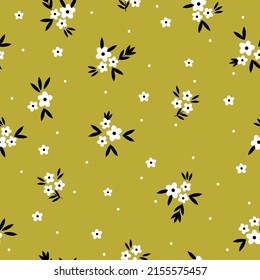 Simple vintage pattern. Small white flowers and dots, black leaves. Mustard background. Fashionable print for textiles, wallpaper and packaging.