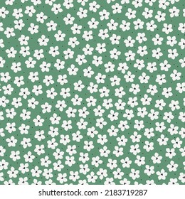 Simple vintage pattern. small white flowers, black dots.green background. Fashionable print for textiles and wallpaper.
