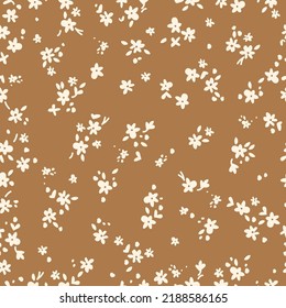 Simple vintage pattern. small white flowers and leaves. brown  background. Fashionable print for textiles and wallpaper.