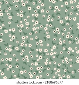 Simple vintage pattern. small white flowers, dark green leaves. green background. Fashionable print for textiles and wallpaper.