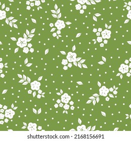 Simple vintage pattern. white flowers, leaves and dots. Green background. Fashionable print for textiles and wallpaper.