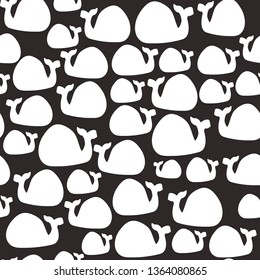 Simple whale pattern. Black background, cute white whales. The print is well suited for postcards,textiles and Wallpapers.