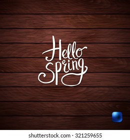 Simple White Texts for Hello Spring Concept Graphic Design on Wooden Background.