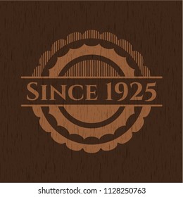 Since 1925 badge with wood background