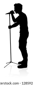 A singer pop, country music, rock star or hiphop rapper artist vocalist singing in silhouette